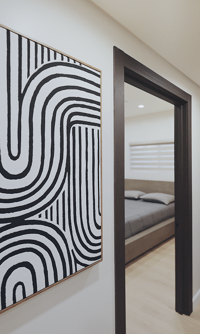 Cozy rehab bedroom with a neatly made bed and a colorful painting on the wall